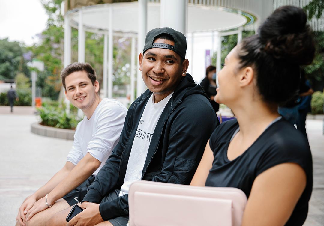 Three students sitting together having a conversation