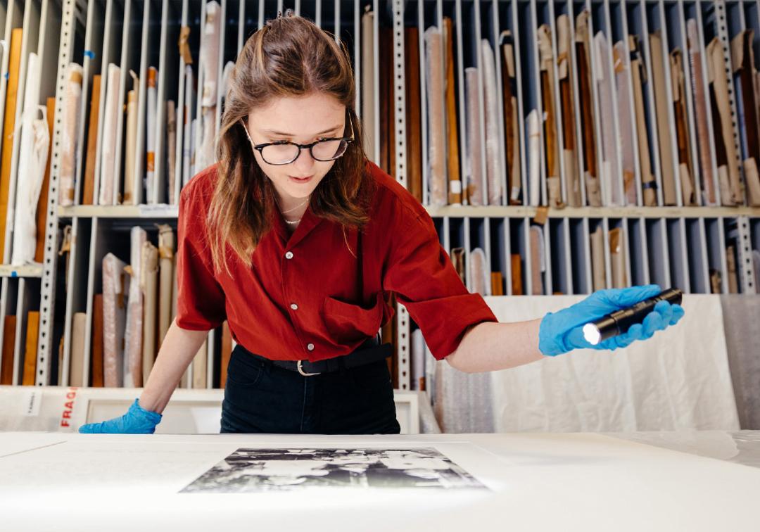 Curator examining photograph