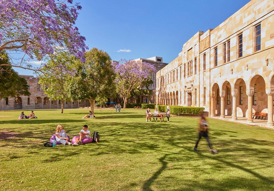 Students sitting on grass in Great Court