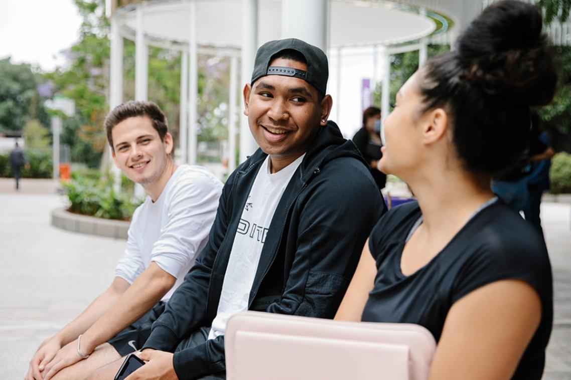 Three students sitting together having a conversation