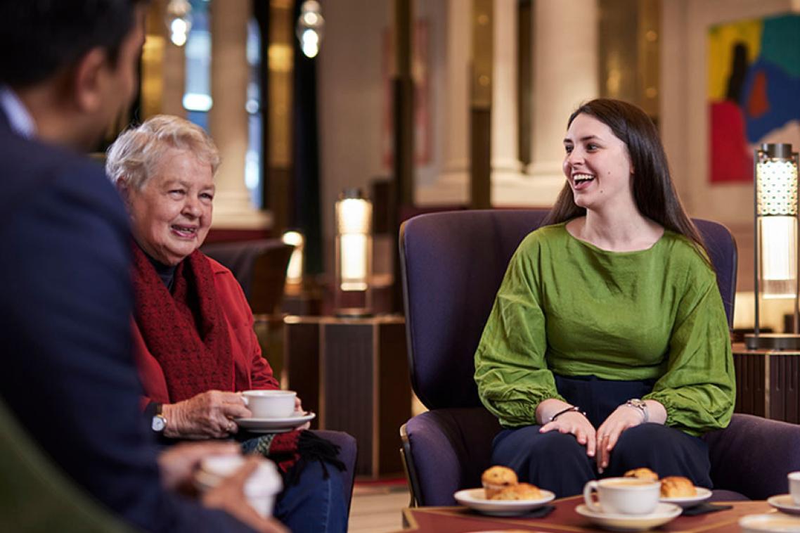 Three people enjoying a chat at 308 Queen St