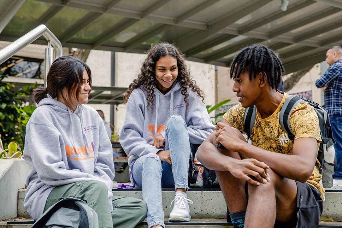 3 indigenous students sitting and talking.