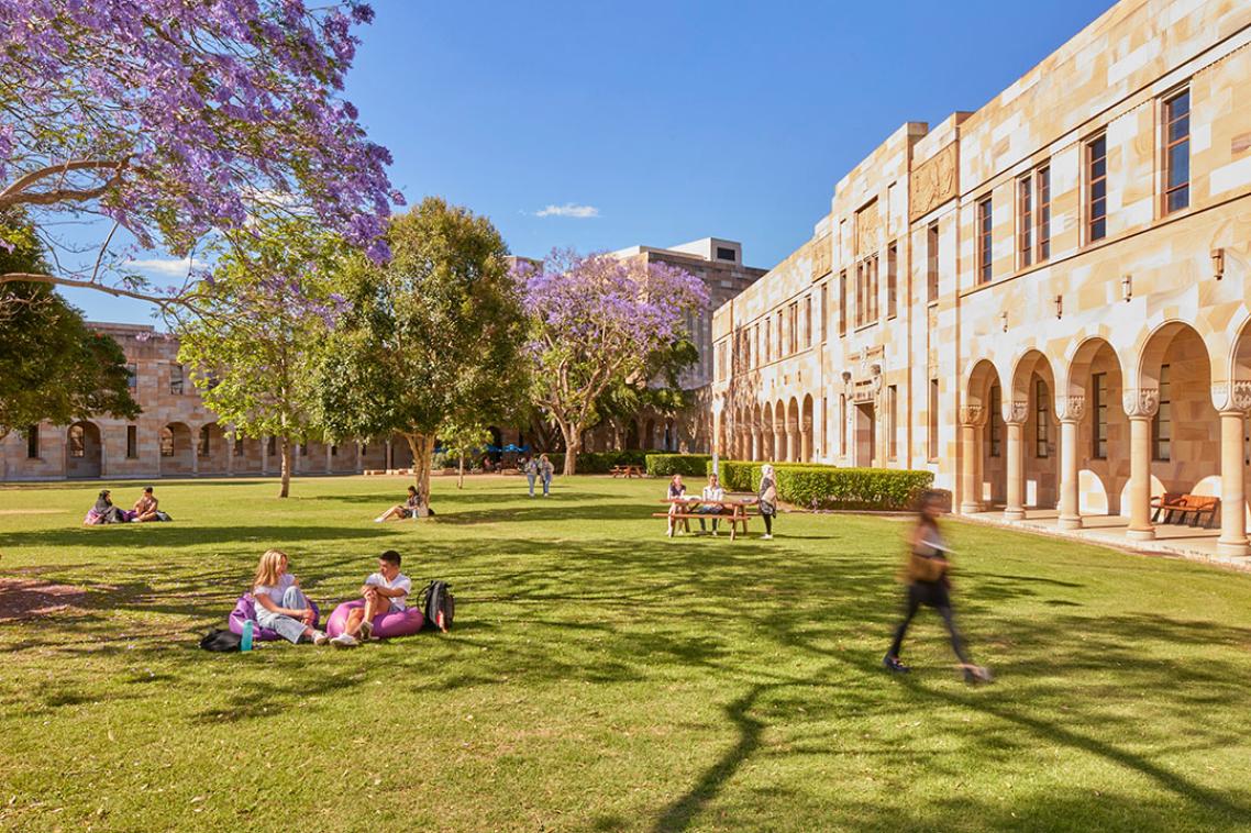 Students sitting on grass in Great Court