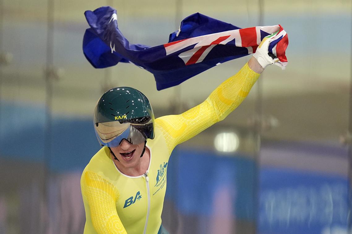 Paralympic cyclist waving the Australian flag