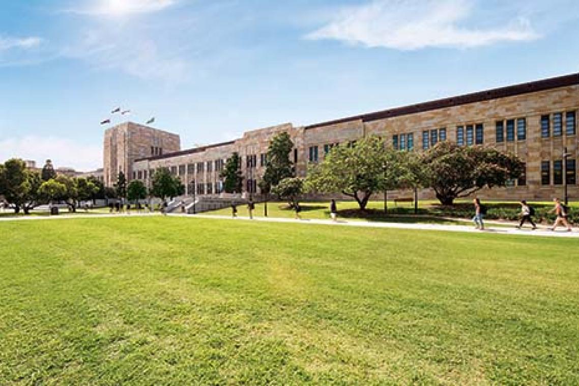 UQ's Forgan Smith building with green lawn in the foreground.