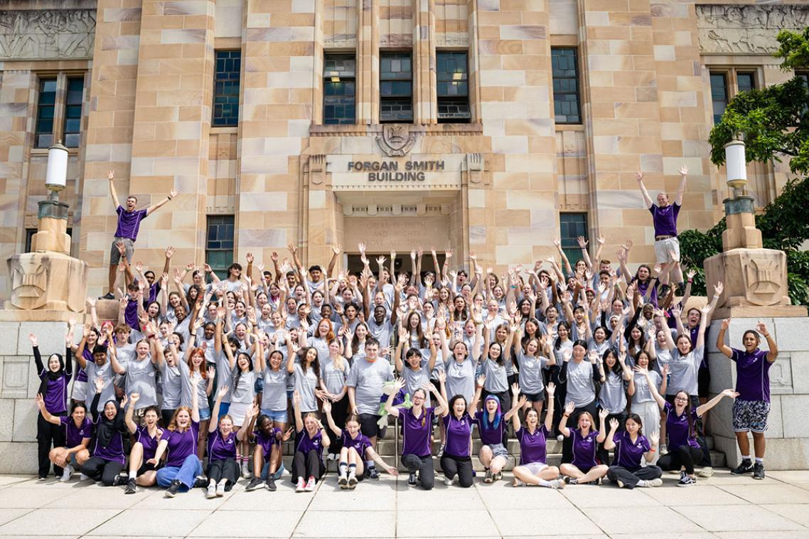Group photo of YAP students standing in front of sandstone building