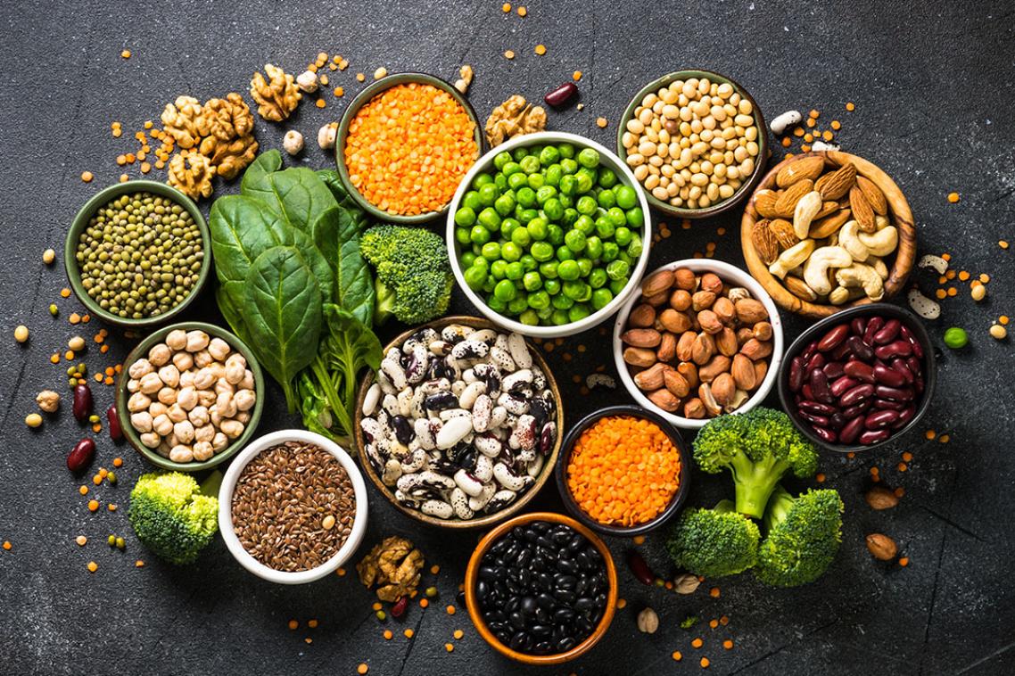 Table with bowls of peas, grains and nuts of all colours